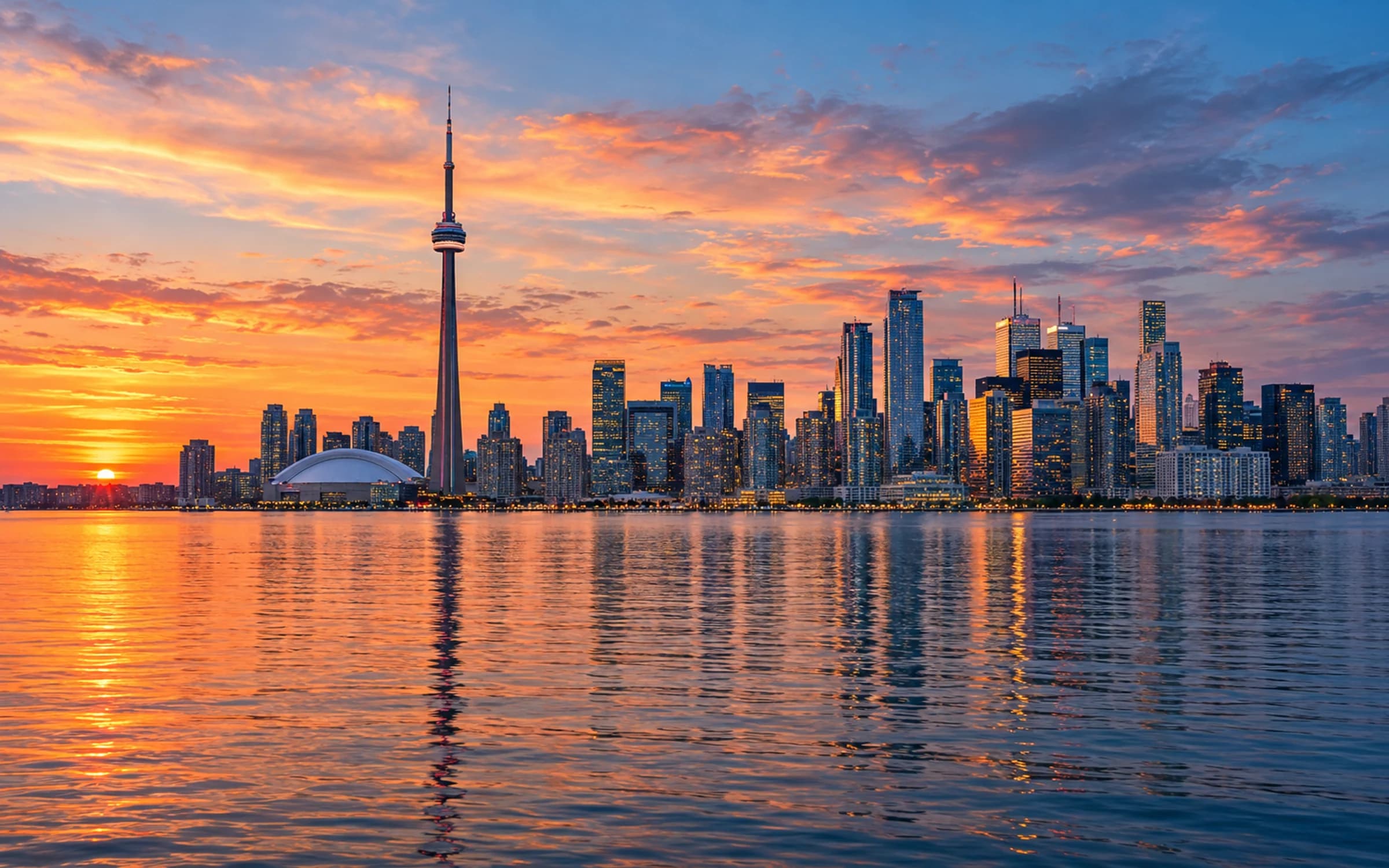 Toronto skyline at sunset seen across Lake Ontario